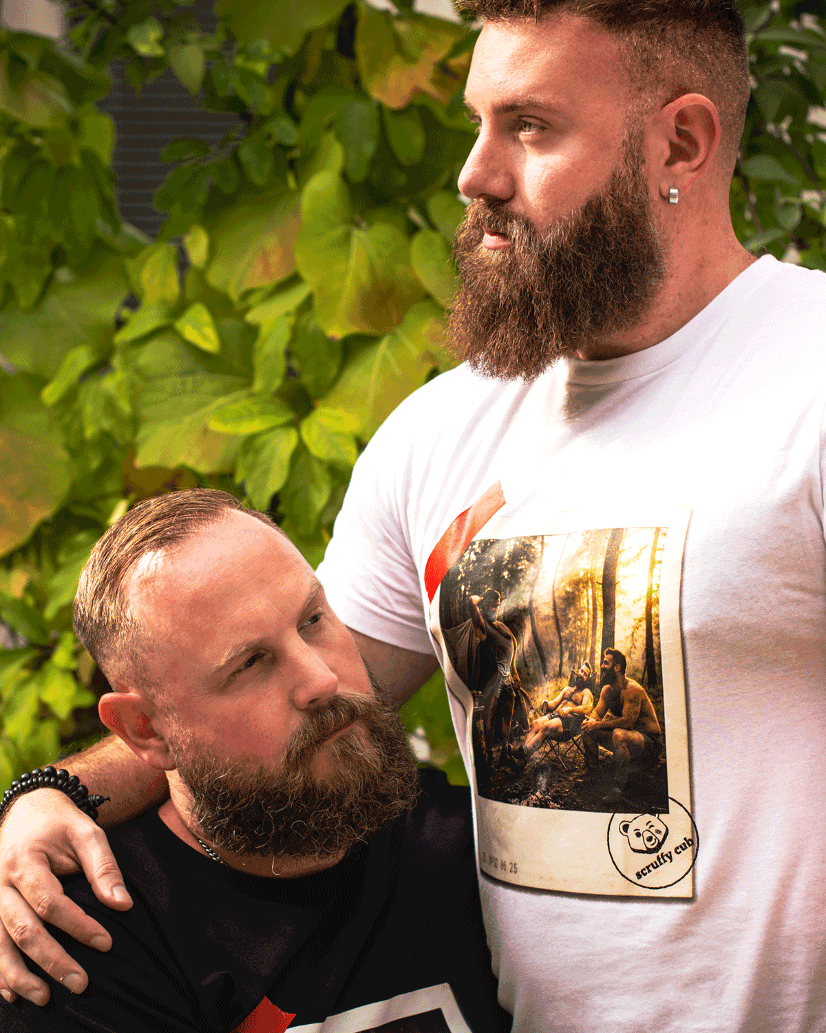 Scruffy Cub Contrast Collection with black Unleashed and white Composed men’s graphic T-shirts on two bearded models