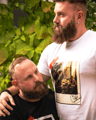 Scruffy Cub Contrast Collection with black Unleashed and white Composed men’s graphic T-shirts on two bearded models