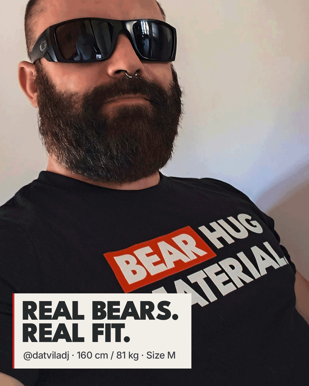 Bearded man wearing black sunglasses and a septum piercing in a black Scruffy Cub “BEAR HUG MATERIAL” T-shirt. A white badge reads “REAL BEARS. REAL FIT.” with @datviladj’s measurements: 160 cm, 81 kg, size M.