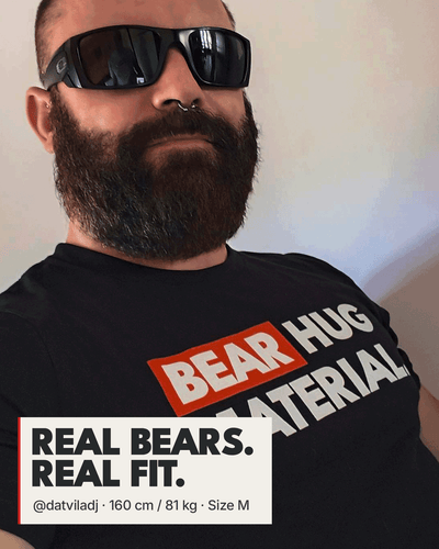 Bearded man wearing black sunglasses and a septum piercing in a black Scruffy Cub “BEAR HUG MATERIAL” T-shirt. A white badge reads “REAL BEARS. REAL FIT.” with @datviladj’s measurements: 160 cm, 81 kg, size M.